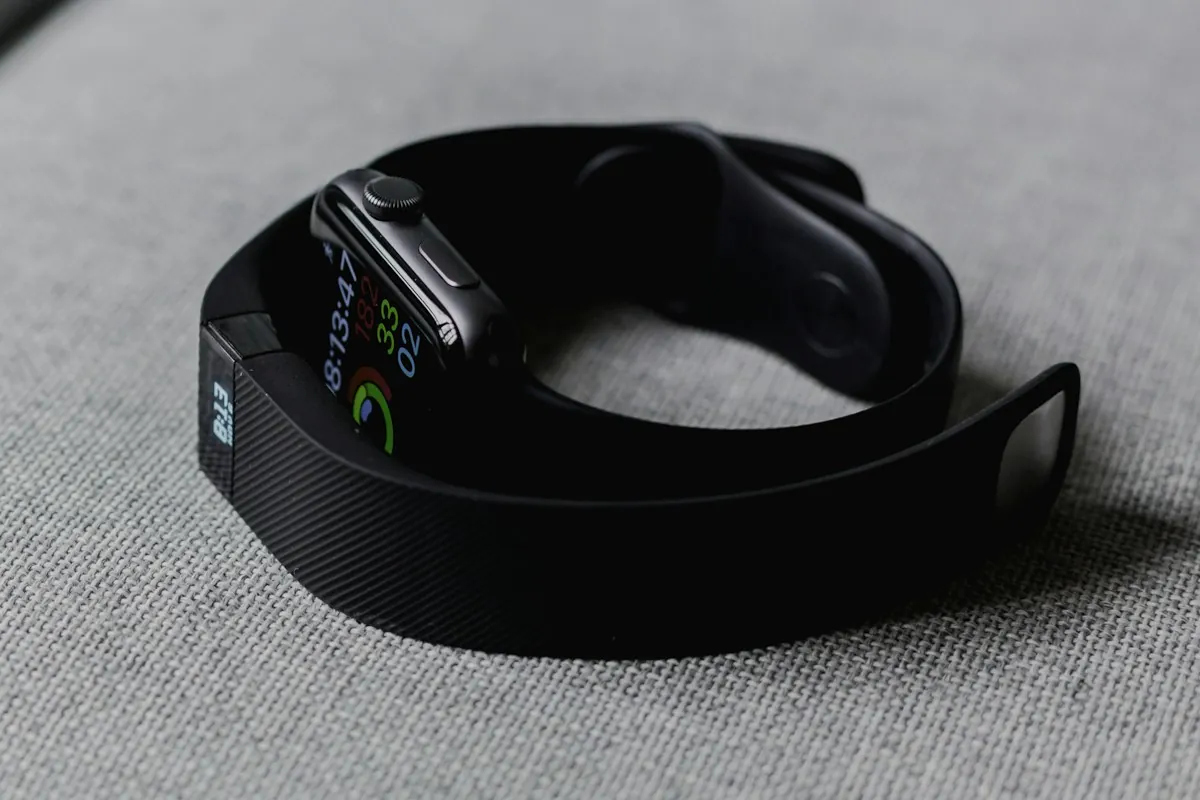 A fitness tracker resting on a gray surface