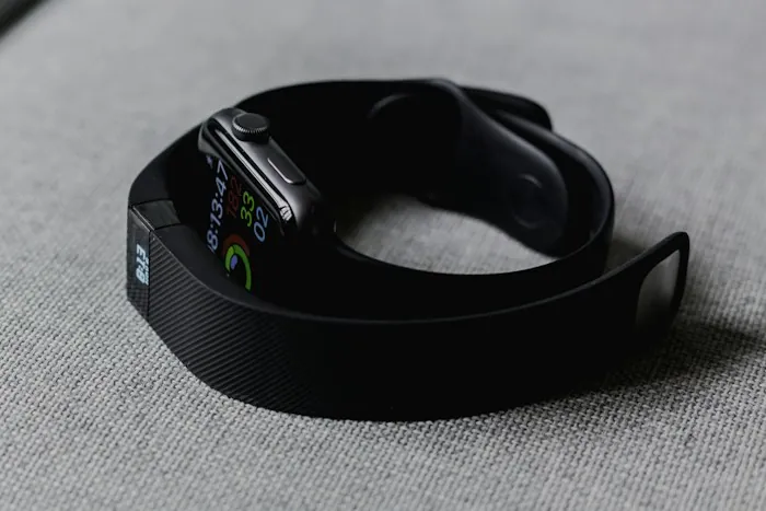 A fitness tracker resting on a gray surface