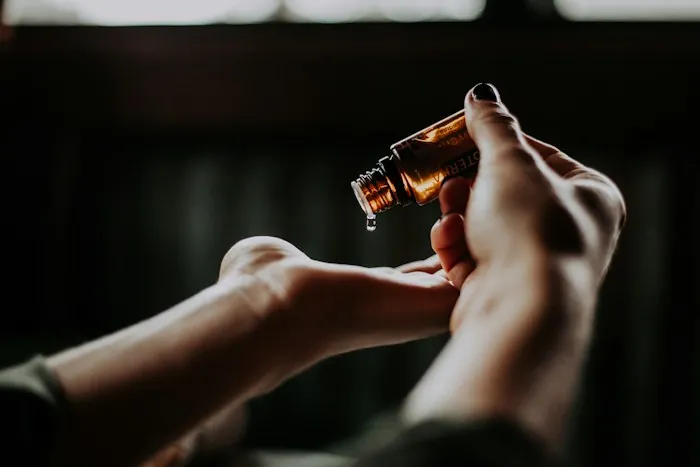 Hands applying a drop of essential oil, part of a calming evening ritual