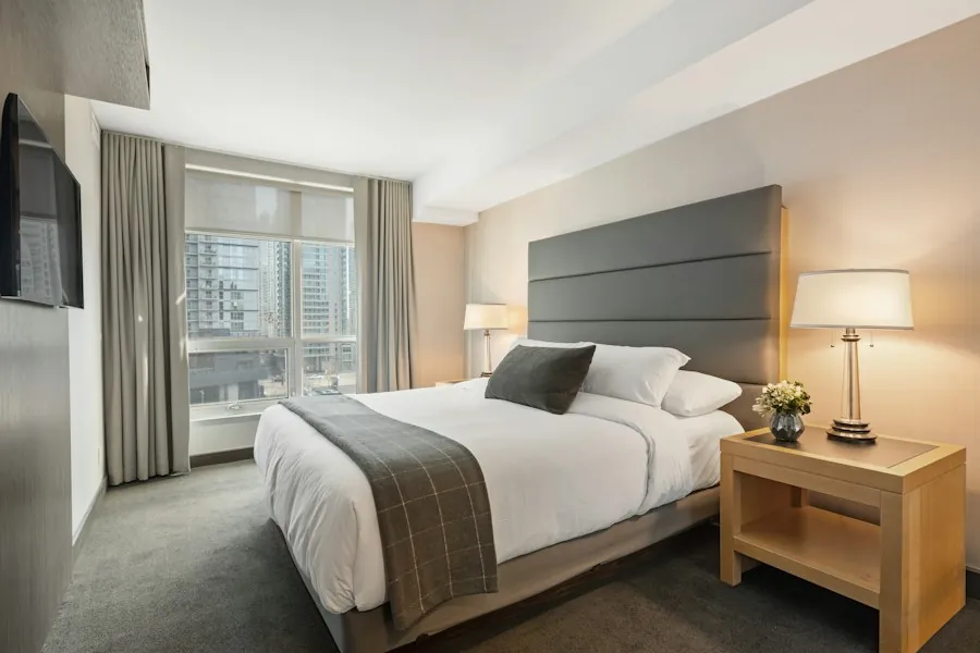 A calm, softly lit bedroom made up for restful sleep