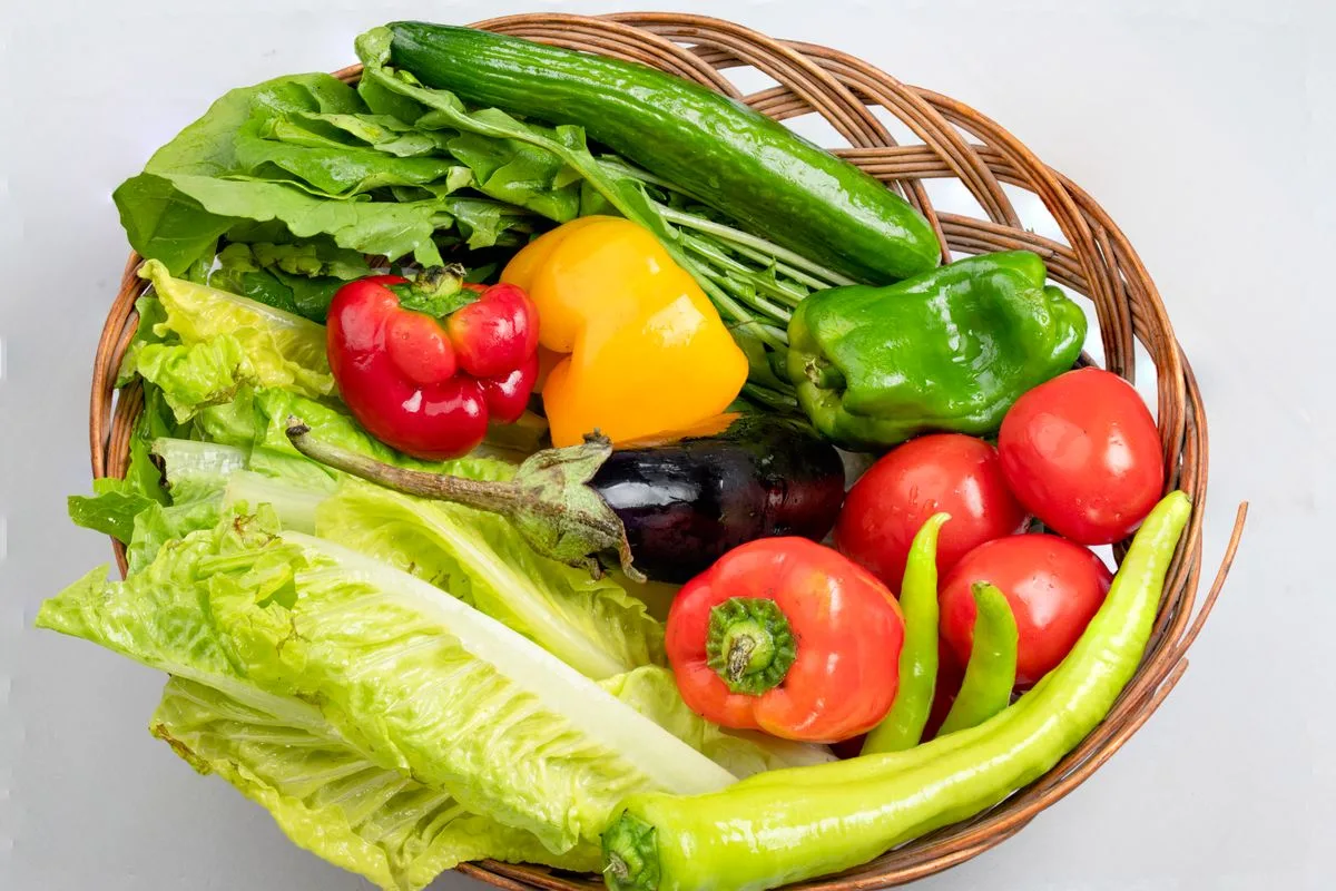 A woven basket filled with colorful fresh vegetables