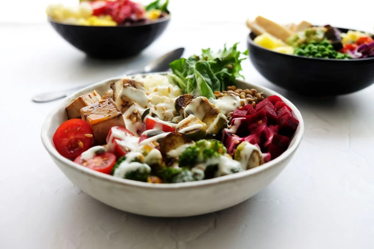 A vegan buddha bowl with tofu, chickpeas, beetroot and greens