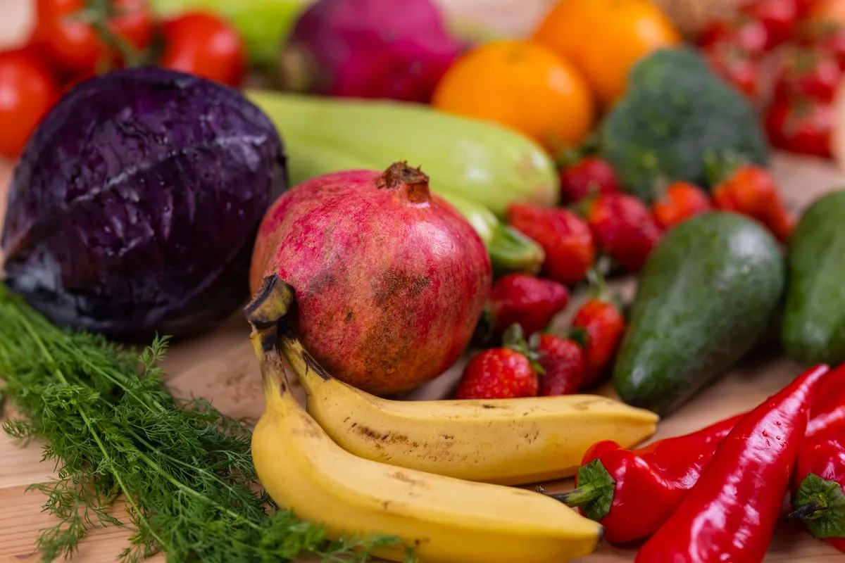 A colorful assortment of fresh vegetables and fruit arranged on a wooden table