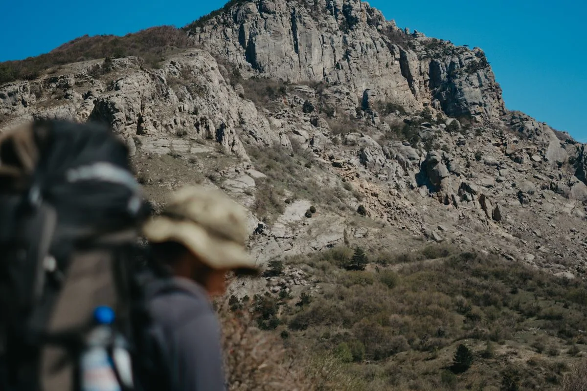 A hiker pausing to take in a clear mountain view, phone put away