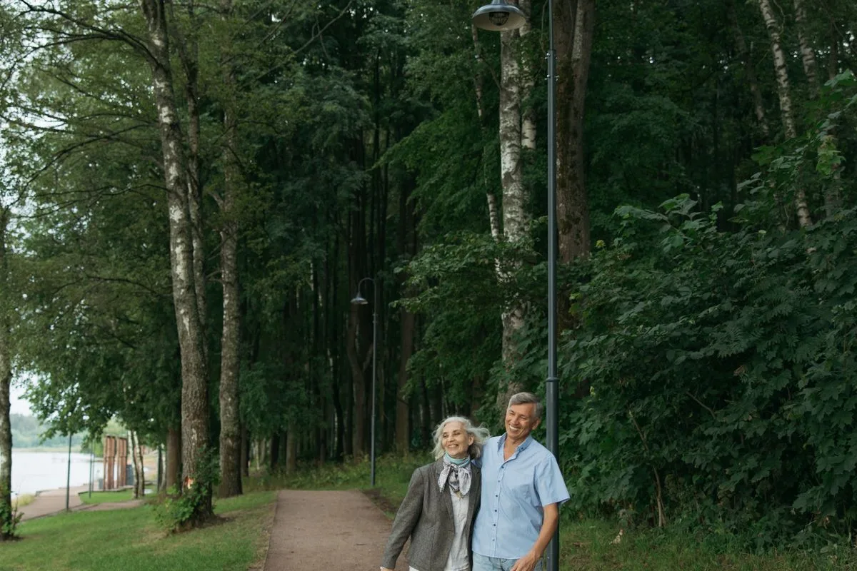 A senior couple enjoying a walk together in a green park